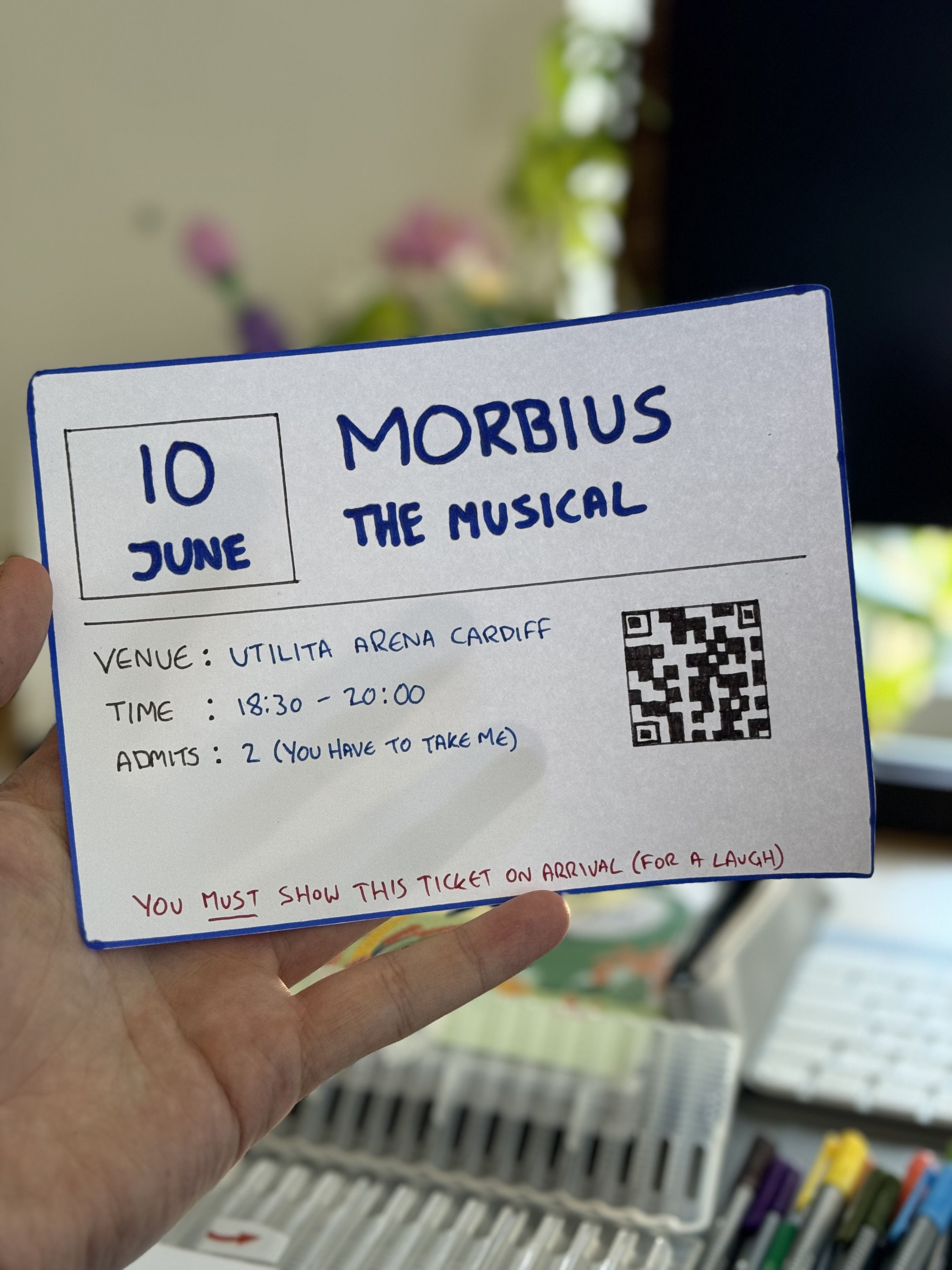 A hand-crafted mock event ticket to Morbius The Musical, featuring event details and a QR code